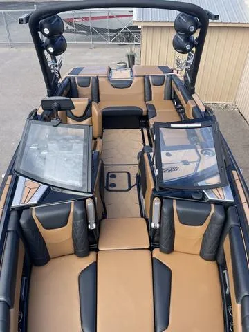 Slide: The Image of 2022 Malibu M220 boat interior with tan and black seating, sleek design, and modern features. - 5