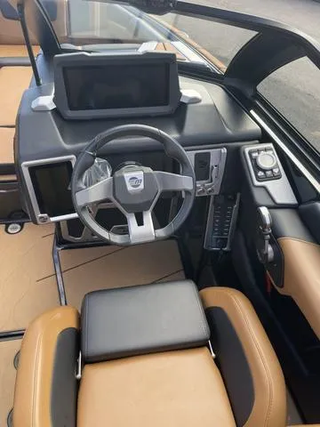 Slide: The Image of 2022 Malibu M220 boat interior with modern dashboard and steering wheel. - 6