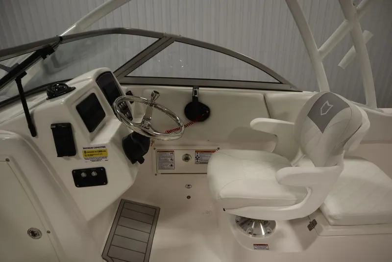 Slide: The Image of 2025 Sea Fox 228 Traveler boat interior with steering wheel and captain's chair. - 15