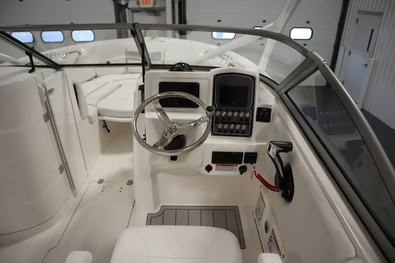 Slide: The Image of 2025 Sea Fox 228 Traveler boat interior with steering wheel and control panel. - 17