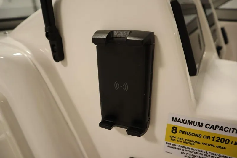 Slide: The Image of Sea Fox 228 Traveler 2025 boat with phone holder and capacity label. - 23