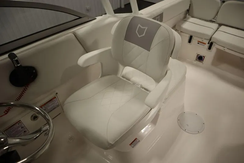 Slide: The Image of 2025 Sea Fox 228 Traveler boat interior with white captain's chair and seating. - 24