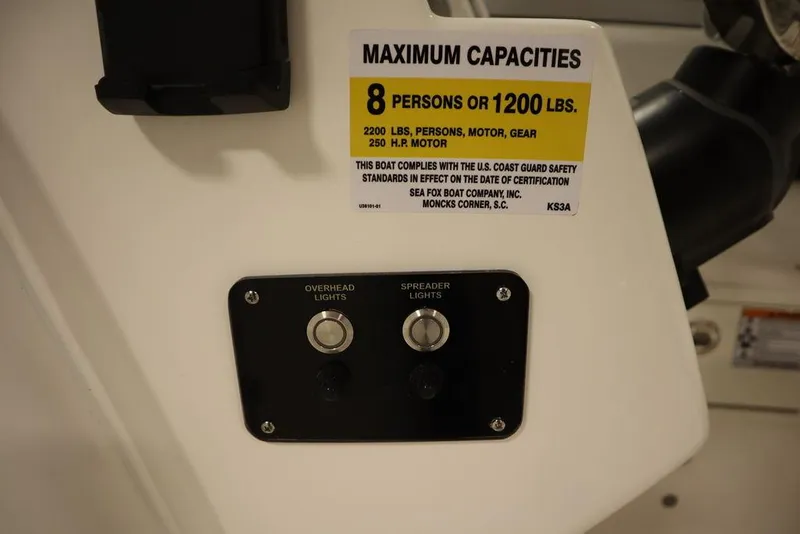 Slide: The Image of Sea Fox 228 Traveler 2025 boat capacity label and light switches. - 25