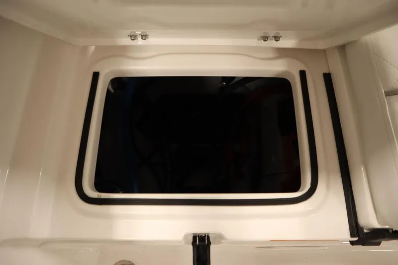 Slide: The Image of 2025 Sea Fox 228 Traveler boat storage compartment with secure latch and rubber seal. - 39