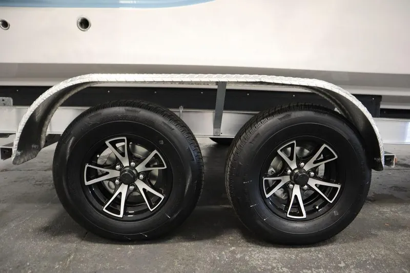 Slide: The Image of 2025 Sea Fox 228 Traveler trailer wheels with sleek black and silver rims. - 48