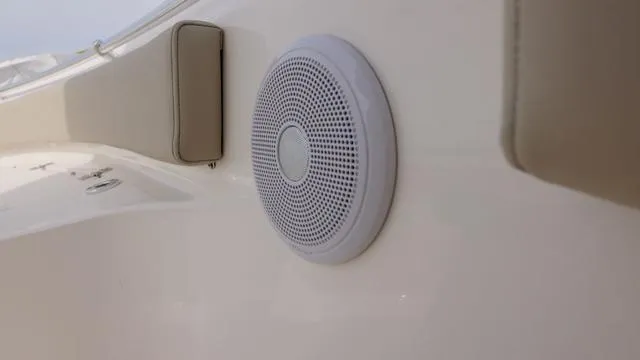 Slide: The Image of 2024 Key West 219 FS boat interior with speaker and cushioned seating. - 10