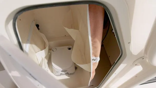 Slide: The Image of 2024 Key West 219 FS boat interior with compact marine toilet. - 11