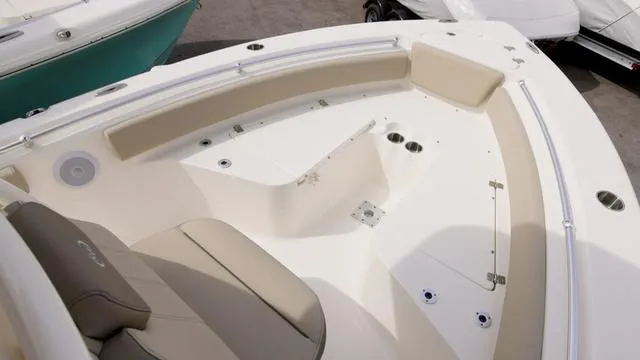 Slide: The Image of 2024 Key West 219 FS boat interior with beige seating and white deck. - 12
