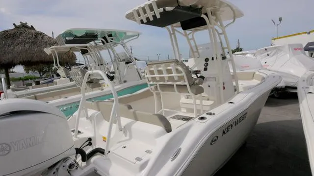 Slide: The Image of 2024 Key West 219 FS boat with Yamaha engine, docked outdoors. - 14