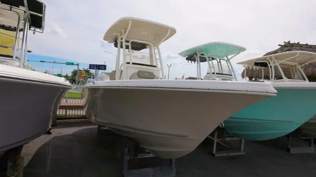 Slide: The Image of 2024 Key West 219 FS boat displayed in a showroom, front view. - 2