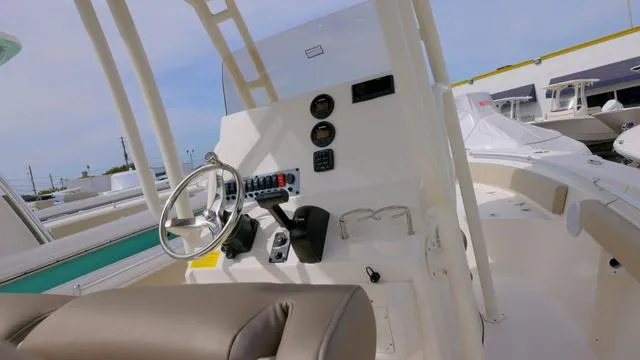 Slide: The Image of 2024 Key West 219 FS boat interior with steering wheel and control panel. - 6