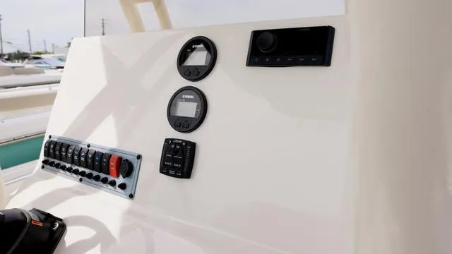 Slide: The Image of 2024 Key West 219 FS boat dashboard with gauges and controls. - 7