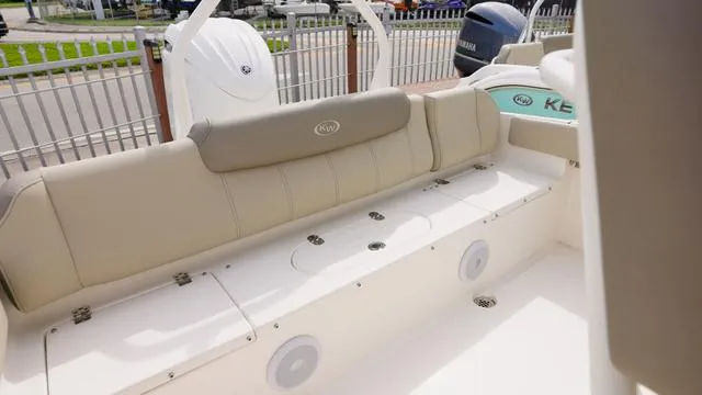 Slide: The Image of 2024 Key West 219 FS boat interior with beige seating and storage compartments. - 9