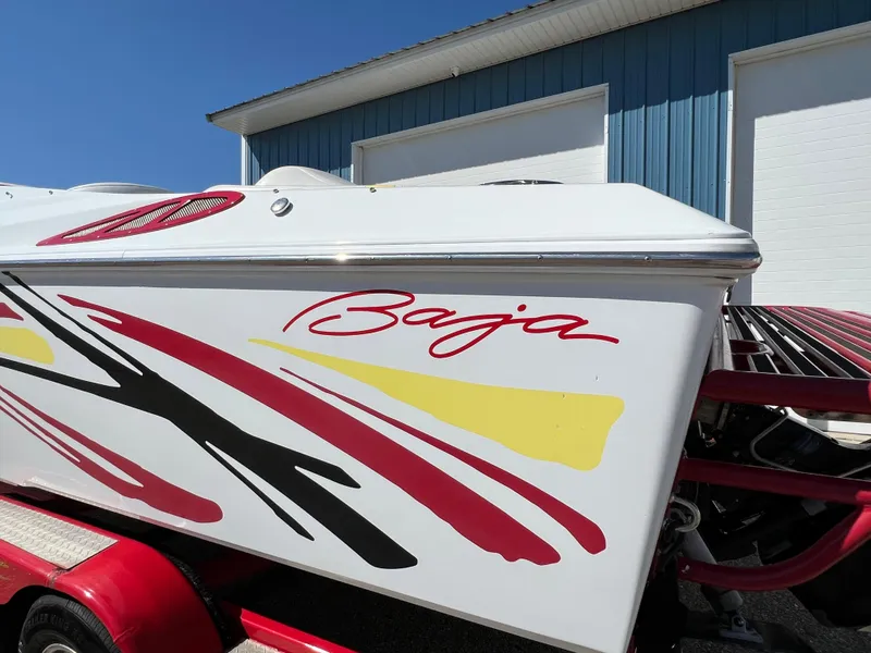 Slide: The Image of 2005 Baja Outlaw boat with colorful graphics on a trailer. - 14