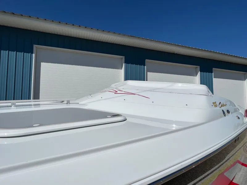 Slide: The Image of 2005 Baja Outlaw boat in front of blue storage units. - 22