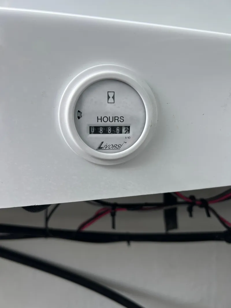 Slide: The Image of Hour meter on 2005 Baja Outlaw boat dashboard, displaying usage hours. - 26