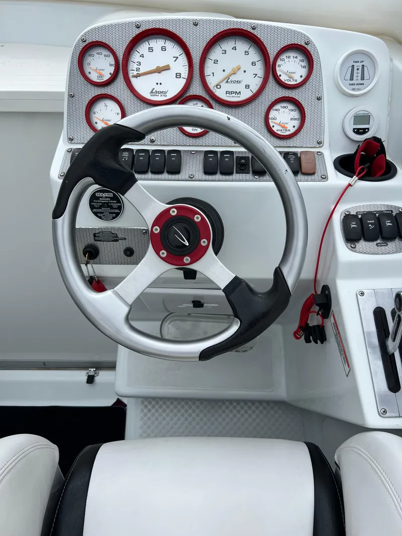 Slide: The Image of 2005 Baja Outlaw boat dashboard with steering wheel and gauges. - 27