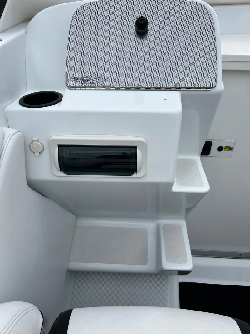 Slide: The Image of 2005 Baja Outlaw boat interior with storage compartments and cup holder. - 28