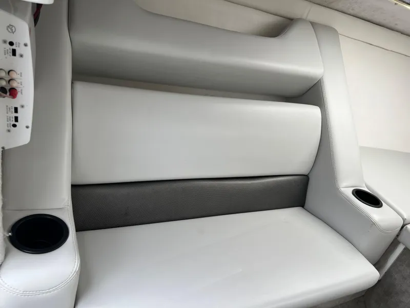 Slide: The Image of 2005 Baja Outlaw boat interior with white seating and cup holders. - 38
