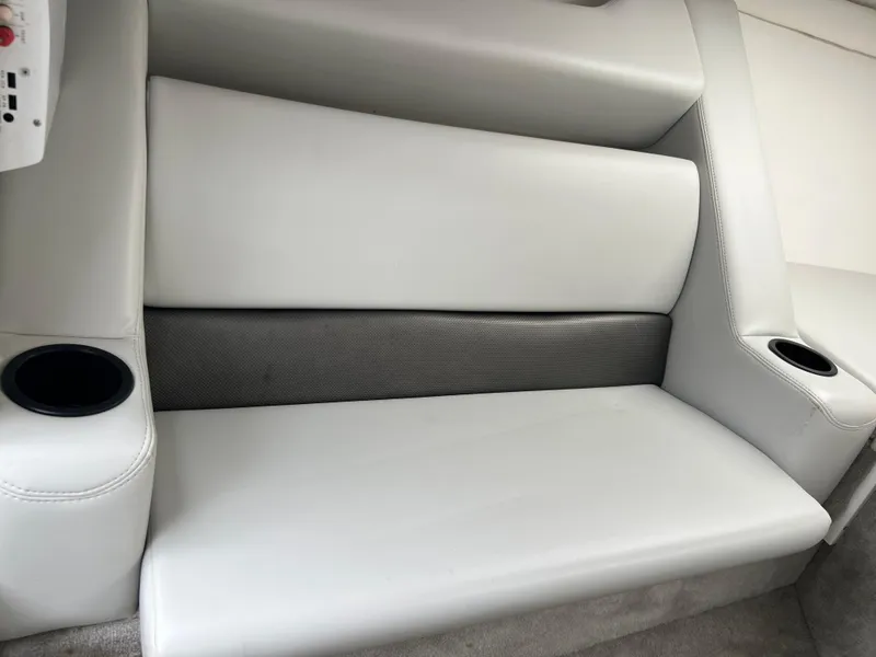 Slide: The Image of 2005 Baja Outlaw boat interior with white leather seating and cup holders. - 41