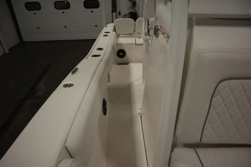 Slide: The Image of 2025 Sea Fox 228 Commander boat interior with white seating and rod holders. - 20