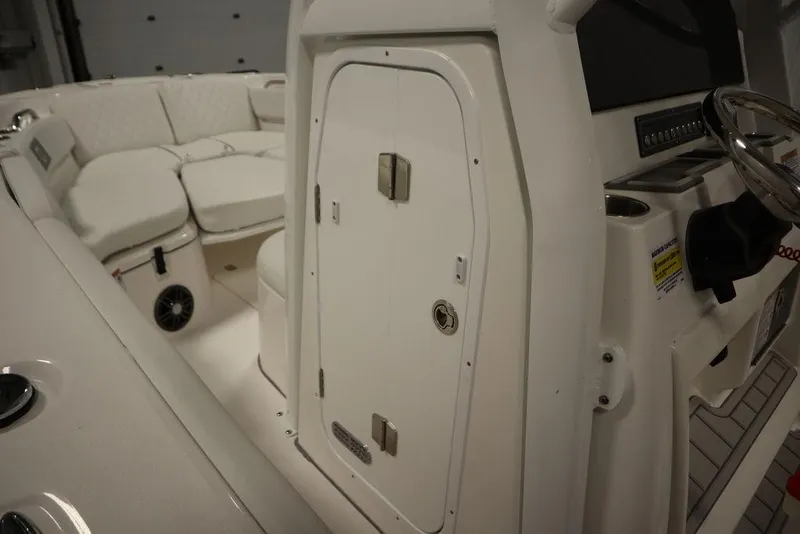 Slide: The Image of 2025 Sea Fox 228 Commander boat interior with seating and control panel. - 21
