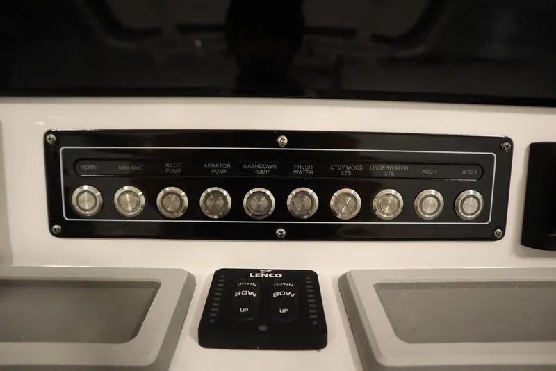Slide: The Image of Control panel of 2025 Sea Fox 228 Commander boat with labeled switches and Lenco trim tab controls. - 27