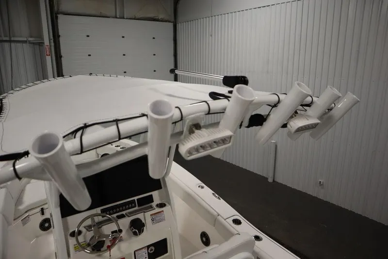 Slide: The Image of 2025 Sea Fox 228 Commander boat interior with rod holders and control panel. - 38