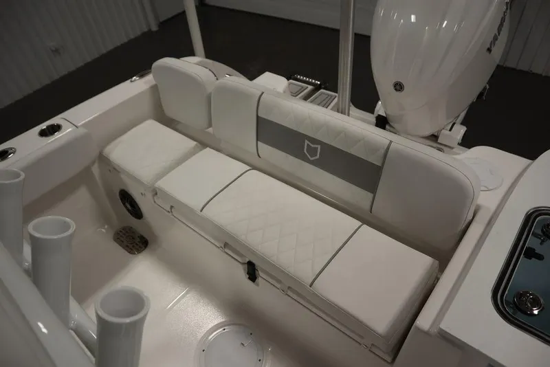 Slide: The Image of 2025 Sea Fox 228 Commander boat interior with white cushioned seating and rod holders. - 39