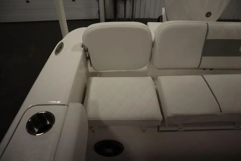 Slide: The Image of 2025 Sea Fox 228 Commander boat interior with white cushioned seating and cup holder. - 42