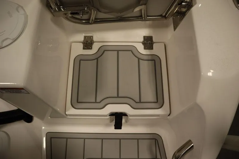 Slide: The Image of 2025 Sea Fox 228 Commander boat storage compartment with secure latch and durable hinges. - 44