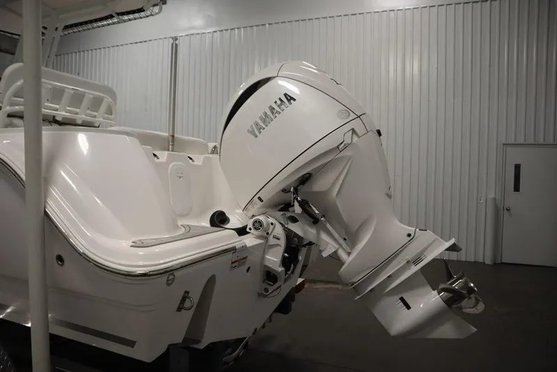 Slide: The Image of 2025 Sea Fox 228 Commander boat with Yamaha outboard motor in a storage facility. - 46