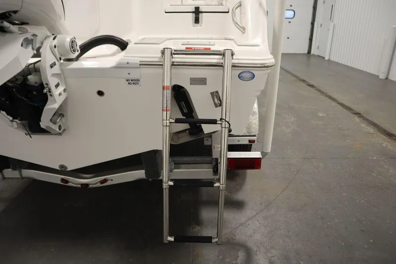 Slide: The Image of 2025 Sea Fox 228 Commander boat with rear ladder in a garage setting. - 47