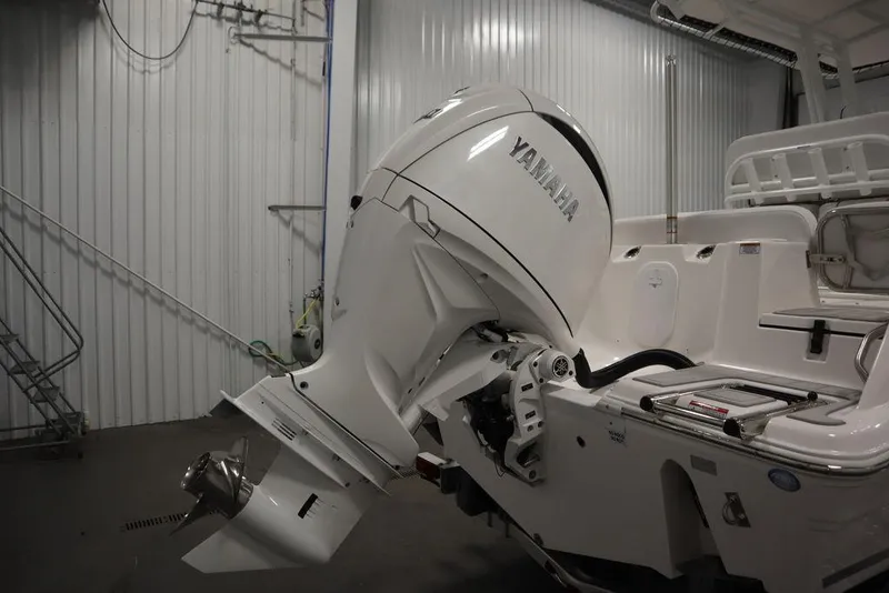 Slide: The Image of 2025 Sea Fox 228 Commander with Yamaha outboard motor in a storage facility. - 48