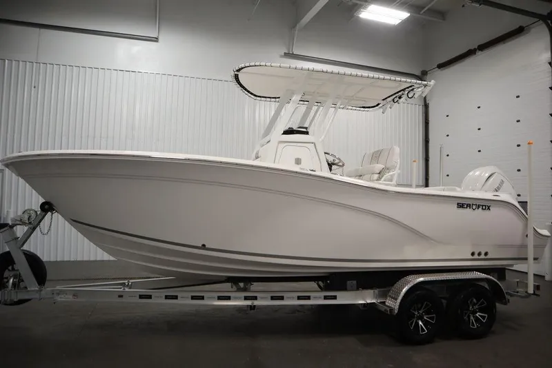 Slide: The Image of 2025 Sea Fox 228 Commander boat on trailer in indoor showroom. - 8