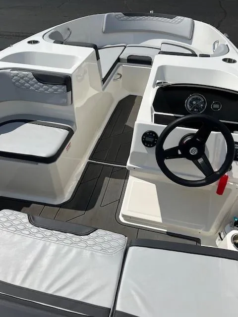 Slide: The Image of 2022 Bayliner Element M17 boat interior with modern seating and steering console. - 4