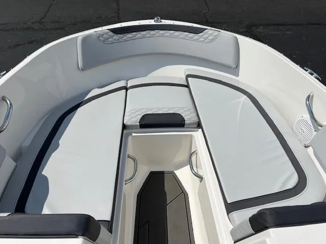 Slide: The Image of 2022 Bayliner Element M17 boat interior with cushioned seating and storage. - 6