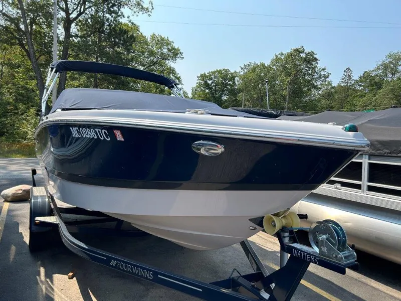 Slide: The Image of 2017 Four Winns H210 boat on trailer, parked outdoors. - 4