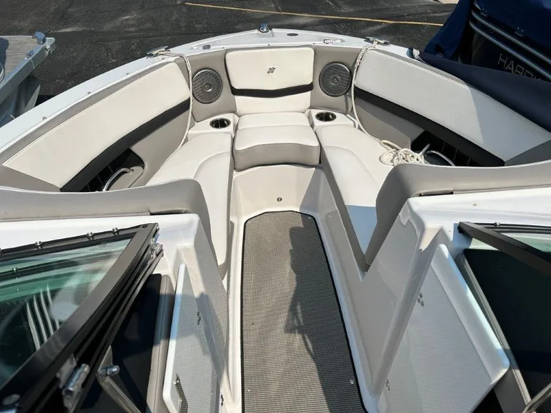 Slide: The Image of 2017 Four Winns H210 boat interior with cushioned seating and cup holders. - 6
