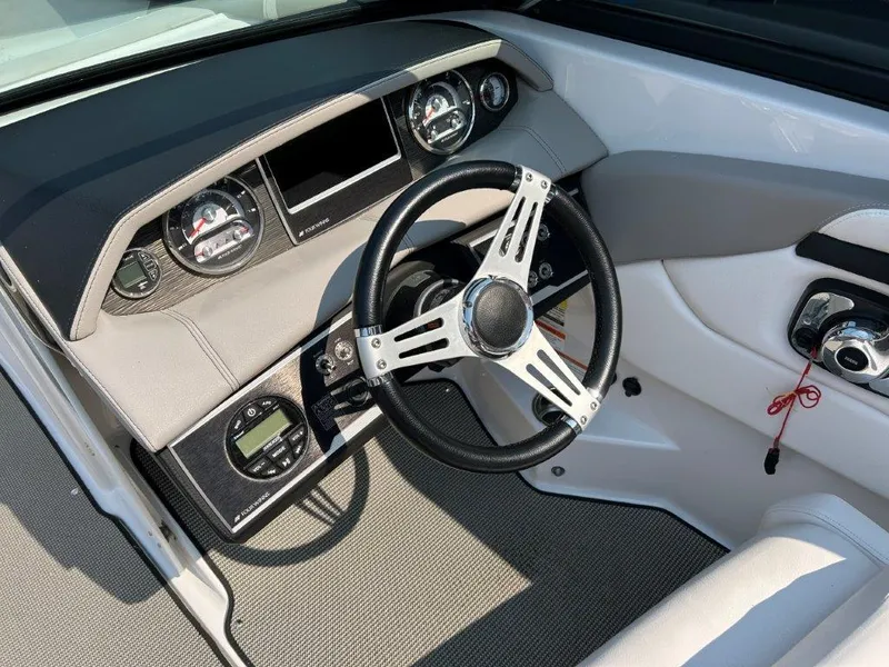 Slide: The Image of 2017 Four Winns H210 boat dashboard with steering wheel and gauges. - 7