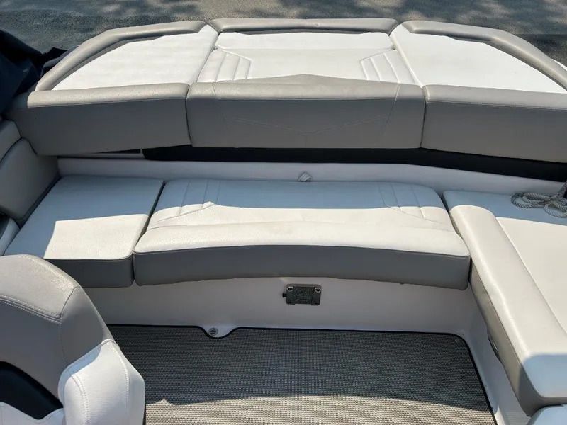 Slide: The Image of 2017 Four Winns H210 boat interior with cushioned seating and carpeted flooring. - 9