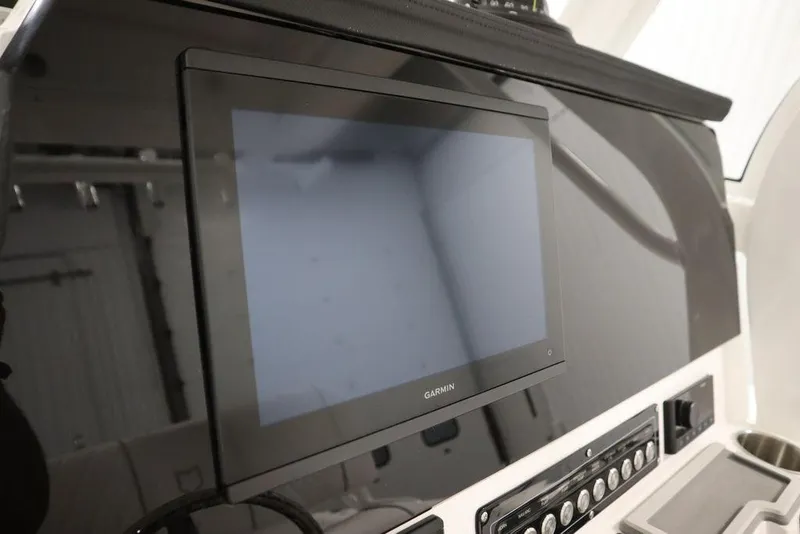 Slide: The Image of 2025 Sea Fox 248 Commander dashboard with Garmin display and control panel. - 25