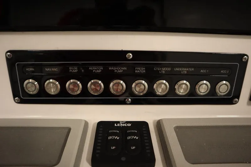 Slide: The Image of Control panel of 2025 Sea Fox 248 Commander boat with labeled switches and Lenco trim tab controls. - 27