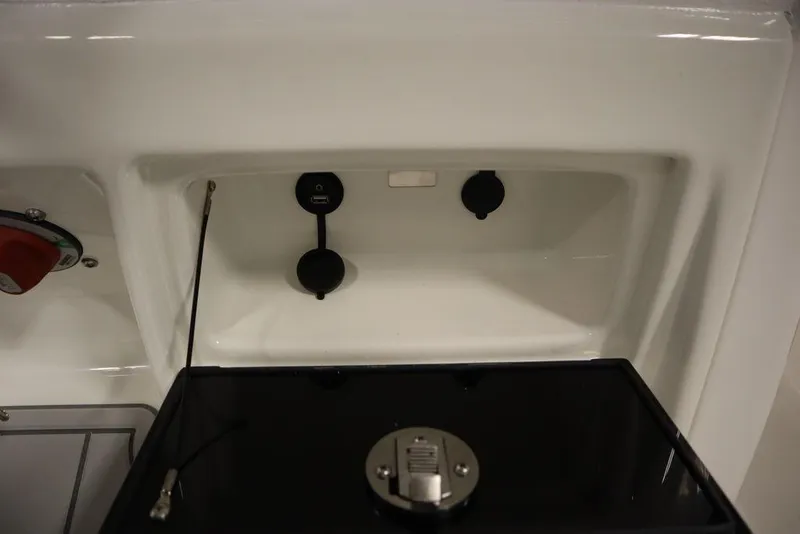 Slide: The Image of 2025 Sea Fox 248 Commander boat interior compartment with control panel and storage area. - 32