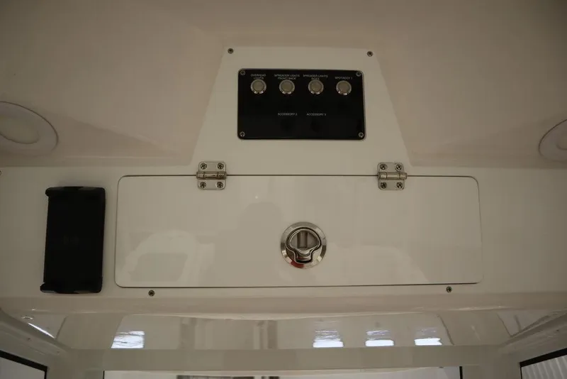 Slide: The Image of 2025 Sea Fox 248 Commander control panel and storage compartment. - 33