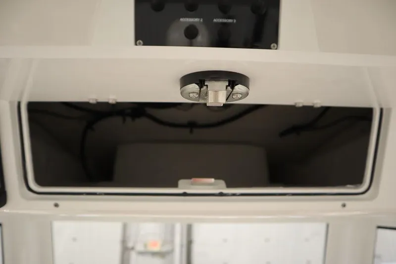 Slide: The Image of 2025 Sea Fox 248 Commander storage compartment with latch and wiring visible. - 35