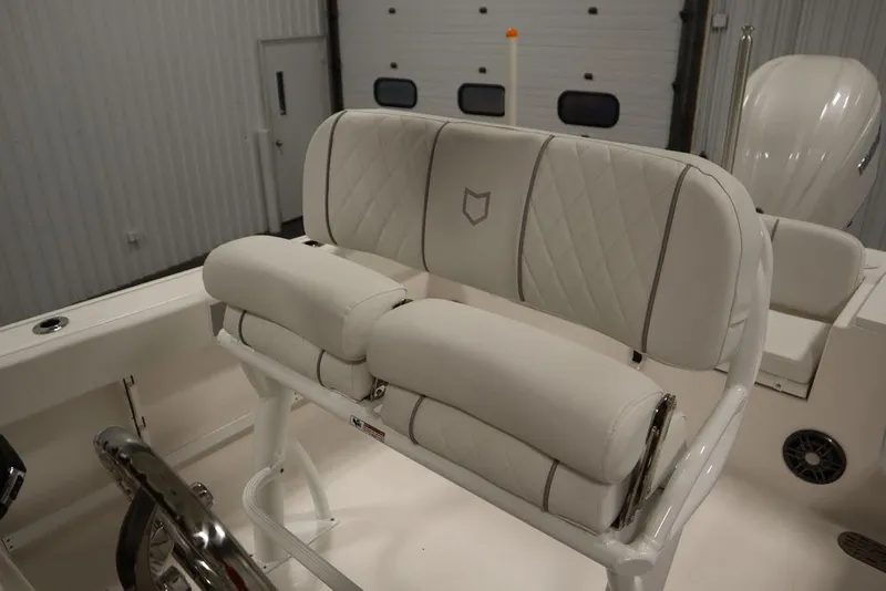 Slide: The Image of 2025 Sea Fox 248 Commander boat seating with white cushioned upholstery in a showroom. - 39