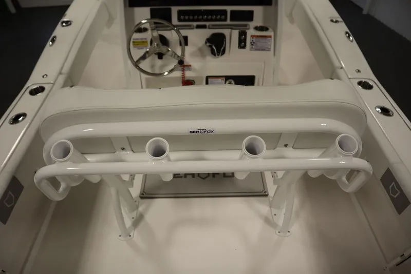 Slide: The Image of 2025 Sea Fox 248 Commander boat interior with steering wheel and rod holders. - 48