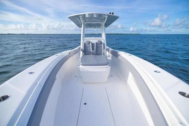 Slide: The Image of 2025 Invincible 33 Open Fisherman boat on open water, clear sky. - 10