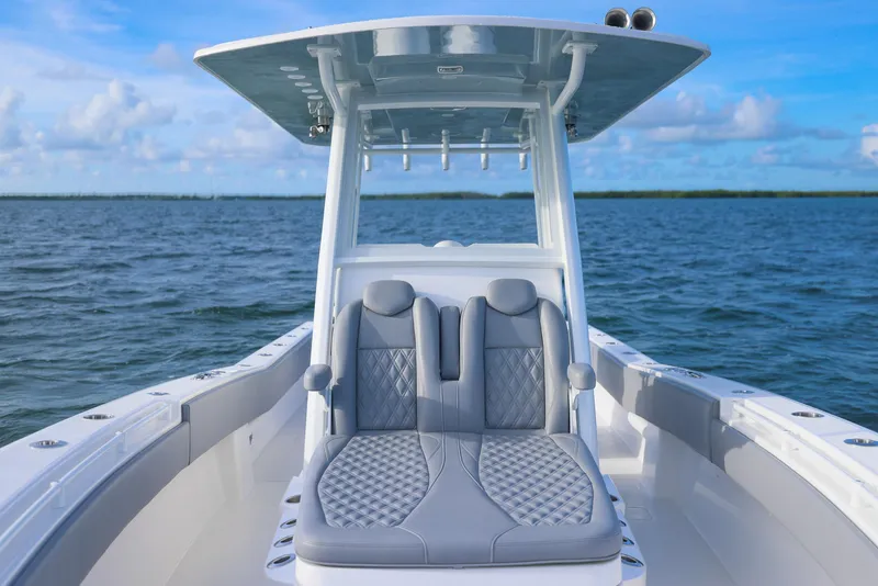 Slide: The Image of 2025 Invincible 33 Open Fisherman boat on open water, featuring sleek seating and modern design. - 11